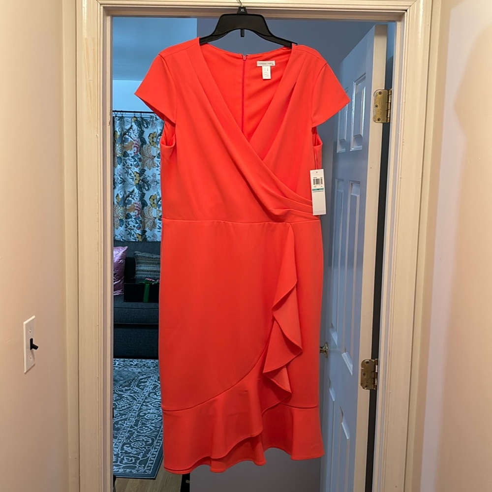 NWT Beautiful coral colored dress. Nice fit ruffles down in front & bottom.